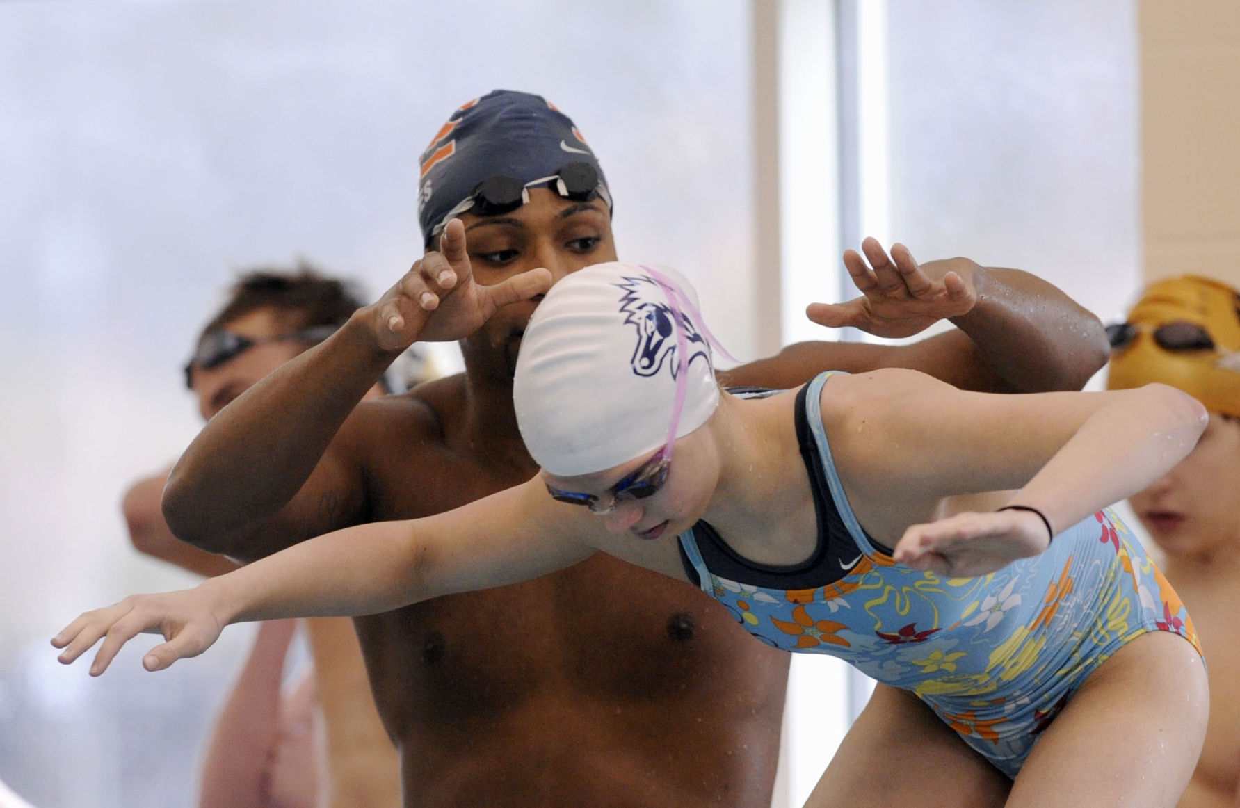 Elite swimmers help local kids improve